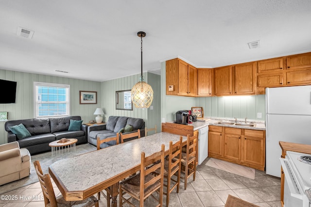1020 Carolina Beach Ave N, Carolina Beach, NC 28428 - kitchen featuring white appliances, light countertops, light tile patterned floors, and open floor plan