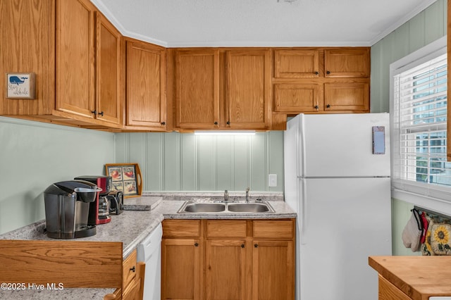 1020 Carolina Beach Ave N, Carolina Beach, NC 28428 - kitchen featuring white appliances and brown cabinetry