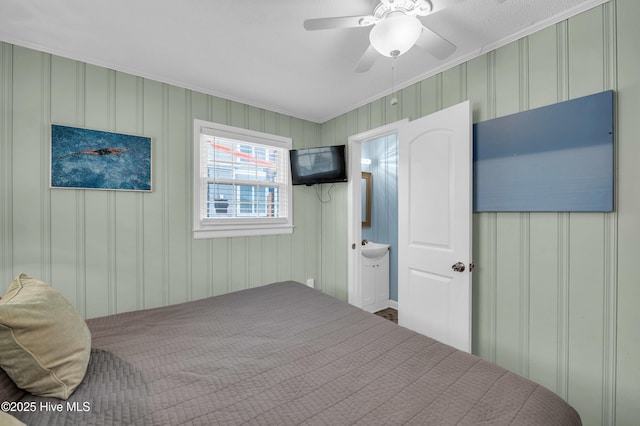 1020 Carolina Beach Ave N, Carolina Beach, NC 28428 - bedroom with crown molding, ceiling fan, a decorative wall, and ensuite bathroom
