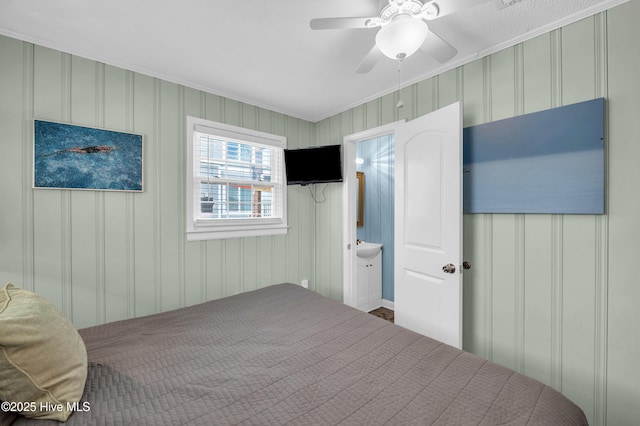 1020 Carolina Beach Ave N, Carolina Beach, NC 28428 - bedroom with a decorative wall, crown molding, ceiling fan, and connected bathroom