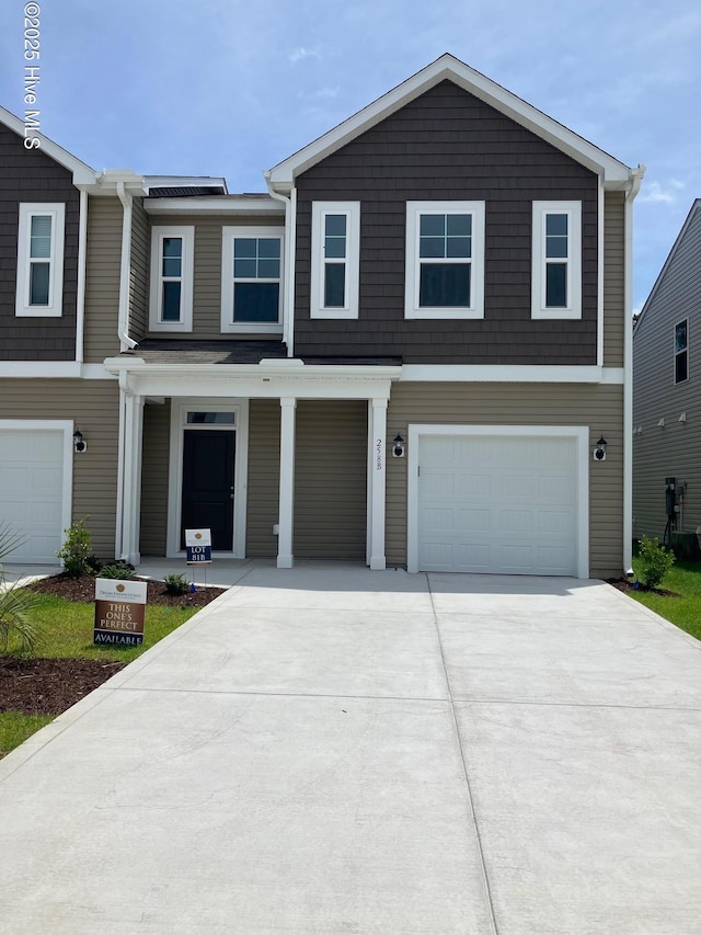 250 Arnette Dr Unit 83B, Ocean Isle Beach, NC 28469 - view of front facade with concrete driveway, a garage, and covered porch