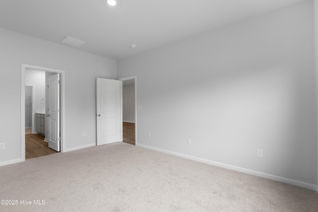 250 Arnette Dr Unit 83B, Ocean Isle Beach, NC 28469 - unfurnished bedroom with carpet, baseboards, and connected bathroom