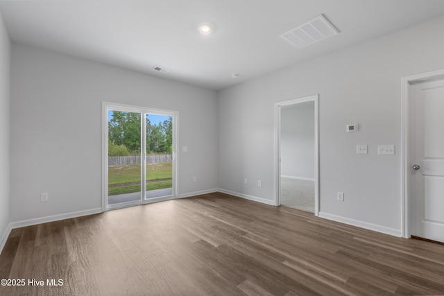 250 Arnette Dr Unit 83B, Ocean Isle Beach, NC 28469 - empty room featuring dark wood finished floors, baseboards, and recessed lighting