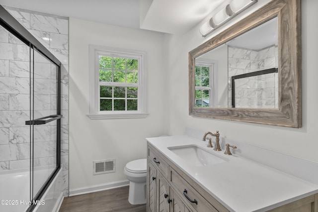 352 Brenda Dr, Wilmington, NC 28409 - bathroom featuring healthy amount of natural light, vanity, toilet, and shower / bath combination with glass door