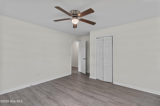 352 Brenda Dr, Wilmington, NC 28409 - unfurnished bedroom featuring wood finished floors, baseboards, a closet, and a ceiling fan