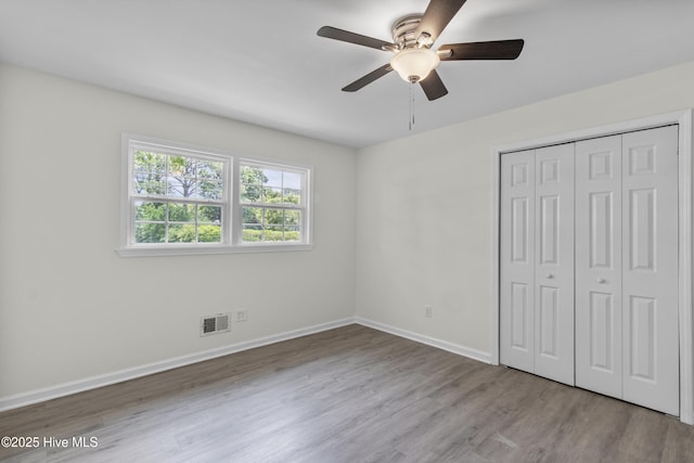 352 Brenda Dr, Wilmington, NC 28409 - unfurnished bedroom featuring wood finished floors, a closet, baseboards, and a ceiling fan