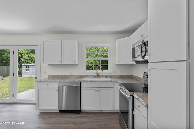 352 Brenda Dr, Wilmington, NC 28409 - kitchen featuring appliances with stainless steel finishes, a sink, white cabinets, dark wood finished floors, and light countertops