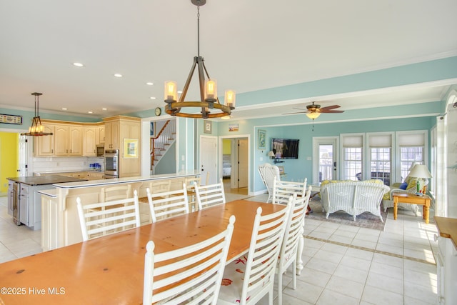 306 Marina Way N, Topsail Beach, NC 28460 - dining area featuring light tile patterned flooring, stairs, crown molding, a chandelier, and ceiling fan
