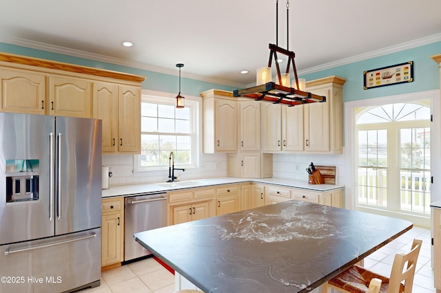 306 Marina Way N, Topsail Beach, NC 28460 - kitchen with stainless steel appliances, light tile patterned floors, a sink, light brown cabinetry, and crown molding