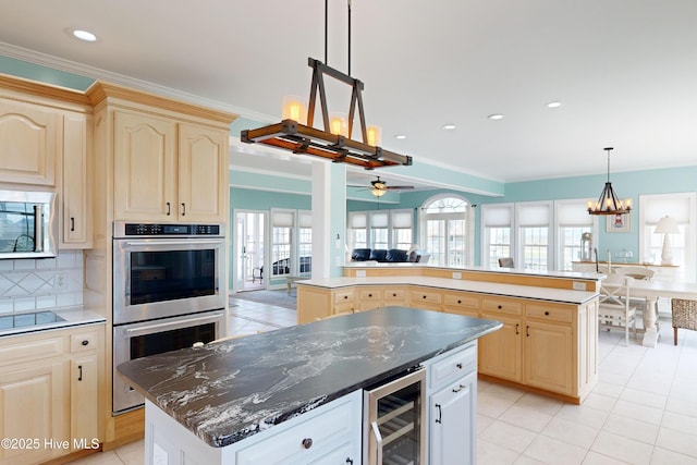 306 Marina Way N, Topsail Beach, NC 28460 - kitchen with beverage cooler, a center island, stainless steel double oven, light brown cabinetry, and crown molding