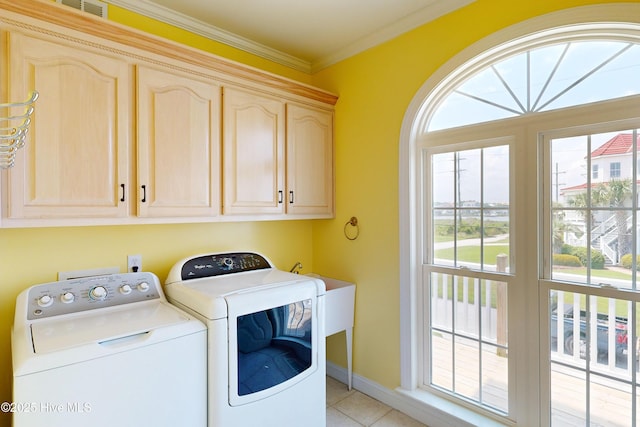 306 Marina Way N, Topsail Beach, NC 28460 - laundry room featuring cabinet space, independent washer and dryer, ornamental molding, light tile patterned floors, and baseboards