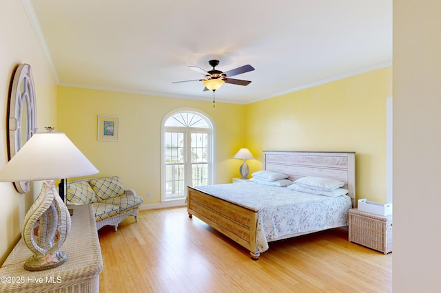 306 Marina Way N, Topsail Beach, NC 28460 - bedroom featuring light wood-style flooring, crown molding, a ceiling fan, and baseboards