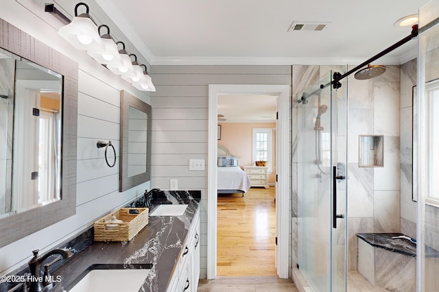 306 Marina Way N, Topsail Beach, NC 28460 - full bathroom featuring ornamental molding, ensuite bathroom, a stall shower, double vanity, and wood finished floors