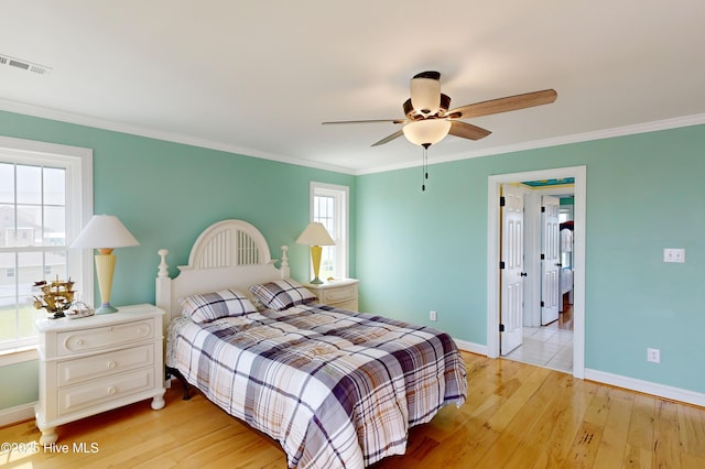 306 Marina Way N, Topsail Beach, NC 28460 - bedroom with light wood-type flooring, baseboards, ornamental molding, and ceiling fan
