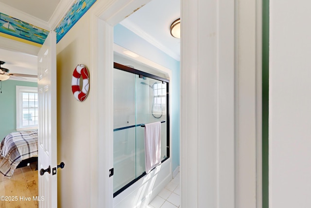 306 Marina Way N, Topsail Beach, NC 28460 - ensuite bathroom with ornamental molding, bath / shower combo with glass door, ceiling fan, baseboards, and tile patterned floors