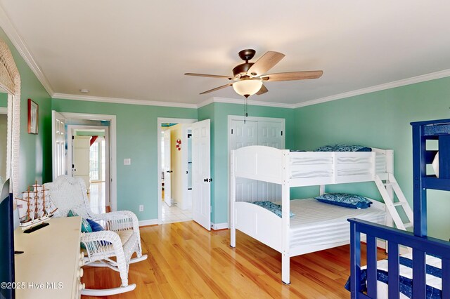 306 Marina Way N, Topsail Beach, NC 28460 - bedroom featuring wood finished floors, ornamental molding, baseboards, ceiling fan, and a closet