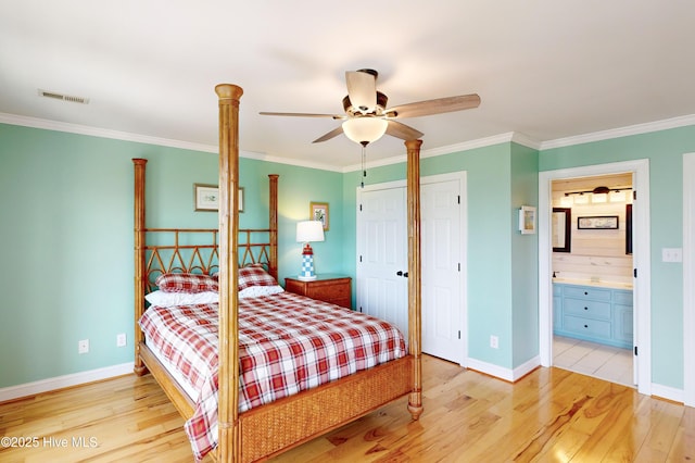 306 Marina Way N, Topsail Beach, NC 28460 - bedroom with light wood-style floors, crown molding, baseboards, a ceiling fan, and ensuite bath