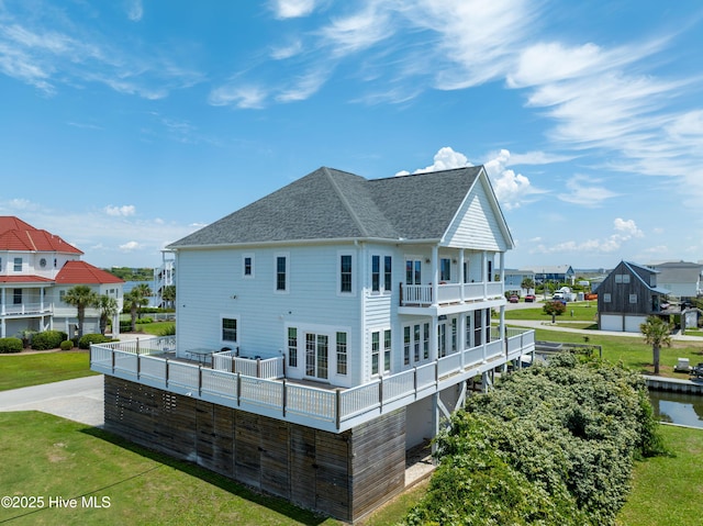 306 Marina Way N, Topsail Beach, NC 28460 - rear view of property with a balcony, roof with shingles, and a lawn
