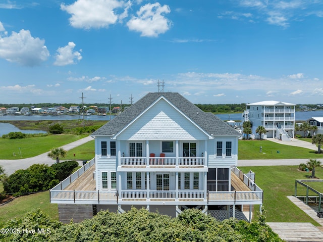 306 Marina Way N, Topsail Beach, NC 28460 - rear view of property featuring a balcony, roof with shingles, a yard, and a water view