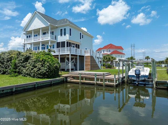 306 Marina Way N, Topsail Beach, NC 28460 - dock area with stairway, boat lift, a balcony, and a water view