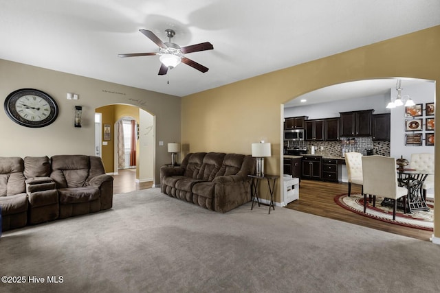 700 Stafford Ln, Jacksonville, NC 28546 - living room with ceiling fan, arched walkways, a chandelier, and wood finished floors