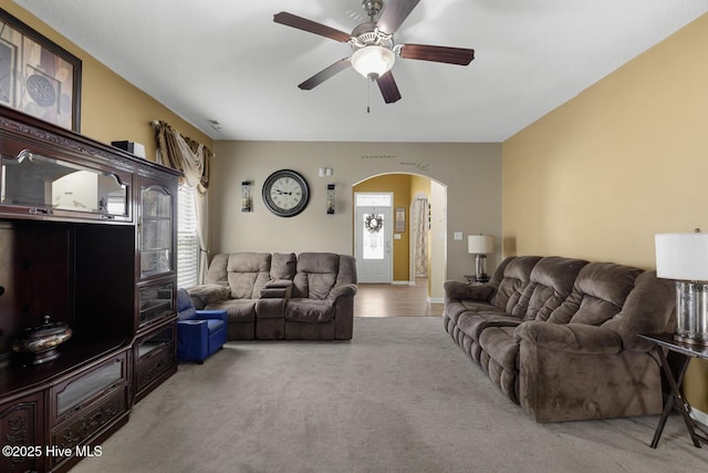 700 Stafford Ln, Jacksonville, NC 28546 - living room featuring arched walkways, ceiling fan, and carpet floors