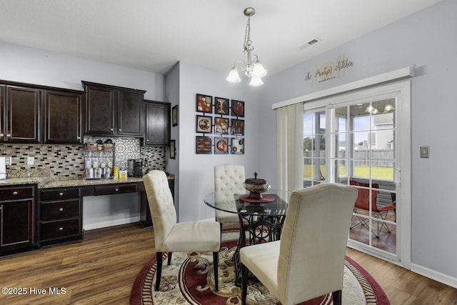 700 Stafford Ln, Jacksonville, NC 28546 - dining space featuring dark wood-style floors, a chandelier, and baseboards