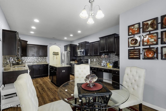 700 Stafford Ln, Jacksonville, NC 28546 - kitchen with stainless steel appliances, a sink, dark wood-style floors, a chandelier, and arched walkways
