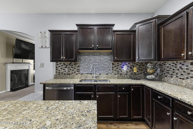 700 Stafford Ln, Jacksonville, NC 28546 - kitchen featuring stainless steel dishwasher, a sink, backsplash, light stone counters, and a high end fireplace