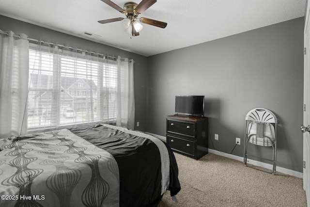 700 Stafford Ln, Jacksonville, NC 28546 - bedroom with baseboards, light carpet, and a ceiling fan