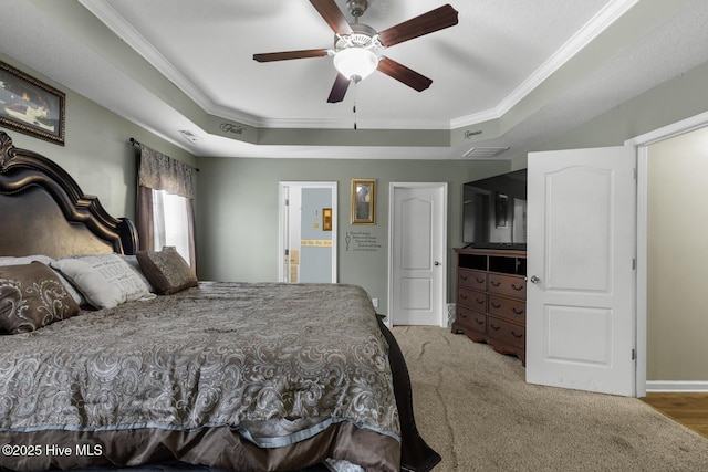 700 Stafford Ln, Jacksonville, NC 28546 - bedroom with a tray ceiling, ornamental molding, baseboards, ensuite bath, and carpet