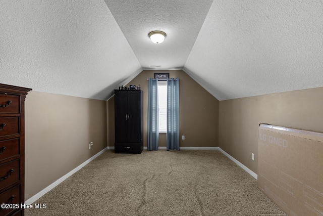 700 Stafford Ln, Jacksonville, NC 28546 - additional living space with a textured ceiling, carpet floors, lofted ceiling, and baseboards