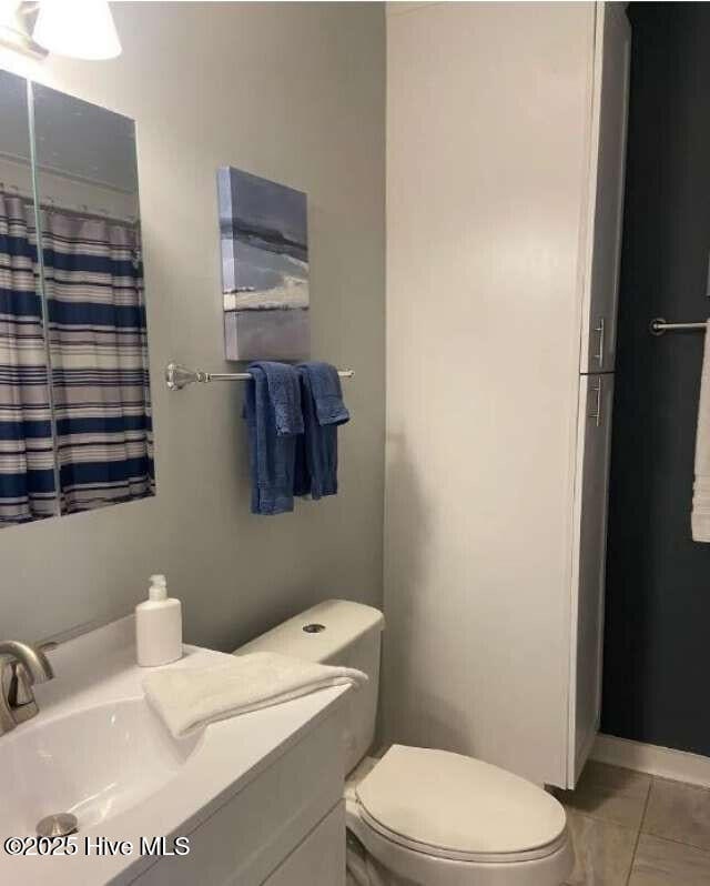 311 N 2nd St Unit B, Wilmington, NC 28401 - bathroom with toilet, tile patterned flooring, and vanity