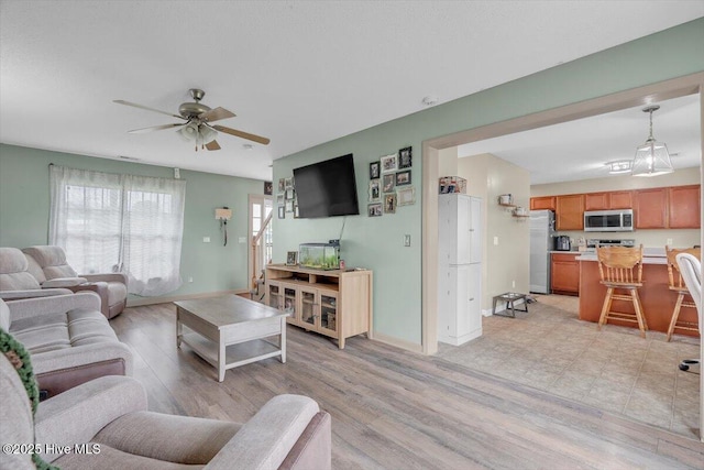 618 Godette School Rd, Havelock, NC 28532 - living room featuring ceiling fan, light wood-style floors, and baseboards
