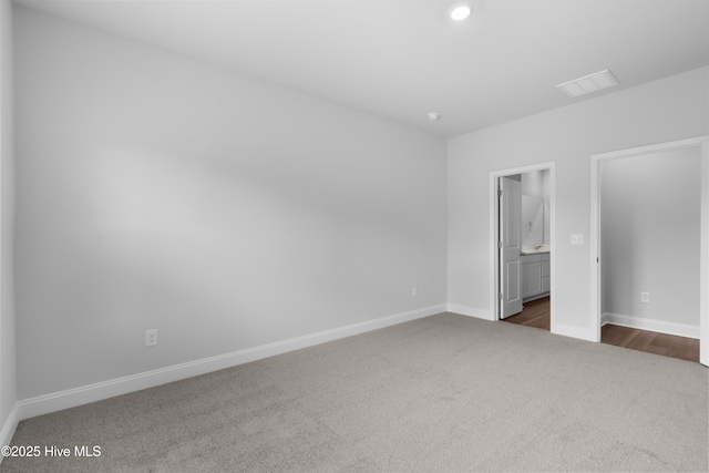 254 Arnette Dr Unit 82B, Shallotte, NC 28469 - unfurnished bedroom featuring dark colored carpet, baseboards, recessed lighting, and ensuite bathroom