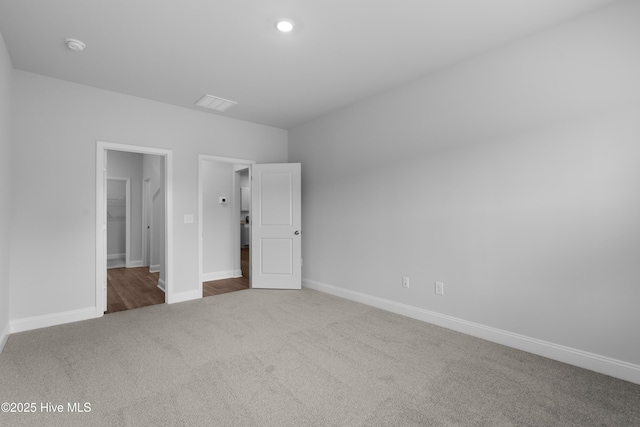 254 Arnette Dr Unit 82B, Shallotte, NC 28469 - unfurnished bedroom featuring carpet flooring, baseboards, a spacious closet, and recessed lighting