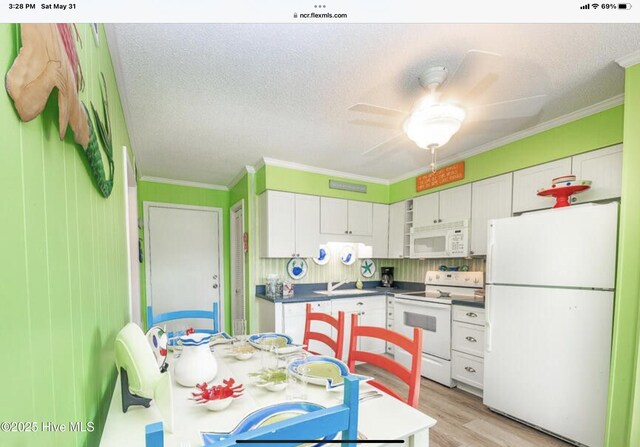 2008 E Ft Macon Rd Unit A6, Atlantic Beach, NC 28512 - kitchen featuring white appliances, white cabinetry, ornamental molding, dark countertops, and a sink
