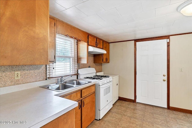 110 Texanna Ln, Raeford, NC 28376 - kitchen featuring a sink, white gas range, under cabinet range hood, light countertops, and brown cabinets