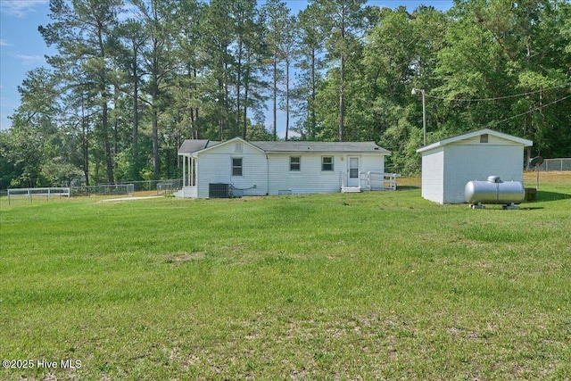 110 Texanna Ln, Raeford, NC 28376 - back of house featuring central AC unit, entry steps, and view of scattered trees