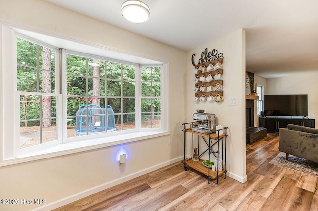 1809 E Indiana Ave, Southern Pines, NC 28387 - dining room featuring light wood finished floors, baseboards, and a large fireplace