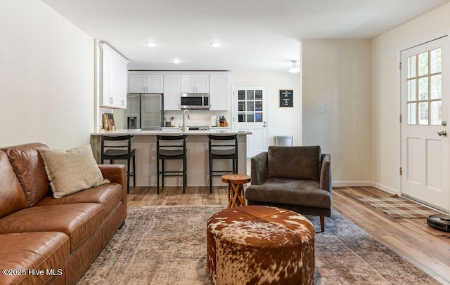 1809 E Indiana Ave, Southern Pines, NC 28387 - living room featuring wood finished floors, baseboards, and recessed lighting