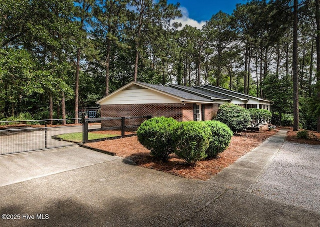 1809 E Indiana Ave, Southern Pines, NC 28387 - view of front of property featuring a gate, view of scattered trees, and brick siding