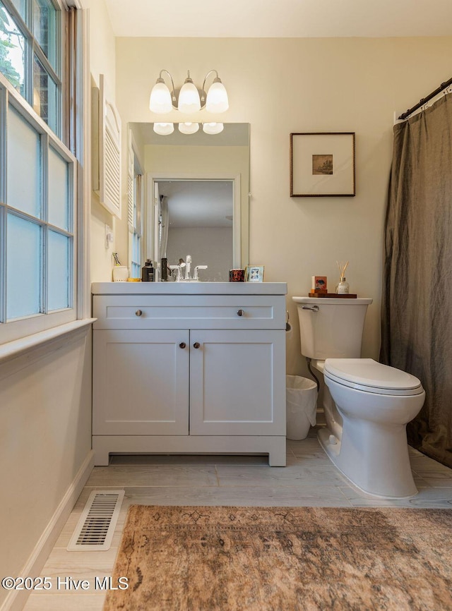1809 E Indiana Ave, Southern Pines, NC 28387 - full bathroom featuring toilet, vanity, baseboards, and wood finished floors