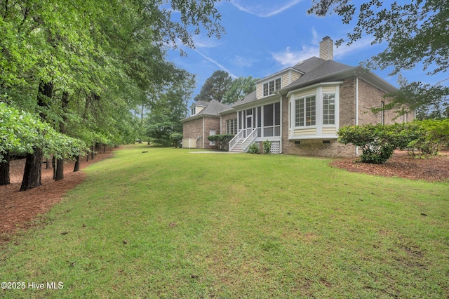 423 White Columns Way, Wilmington, NC 28411 - back of house with a sunroom, brick siding, crawl space, and a yard