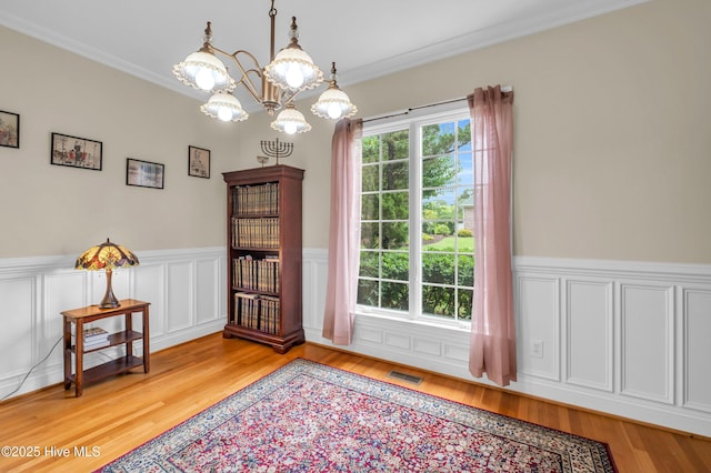 423 White Columns Way, Wilmington, NC 28411 - dining space with light wood-style floors, wainscoting, a chandelier, and crown molding
