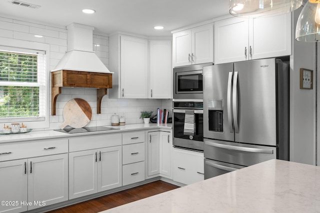2767 Nags Head Rd SW, Supply, NC 28462 - kitchen featuring appliances with stainless steel finishes, white cabinetry, light stone counters, decorative backsplash, and dark wood finished floors