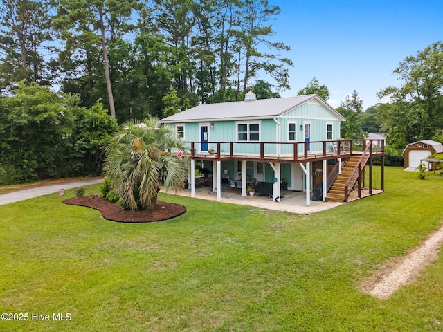 2767 Nags Head Rd SW, Supply, NC 28462 - back of house featuring stairs, a patio area, a deck, metal roof, and a lawn