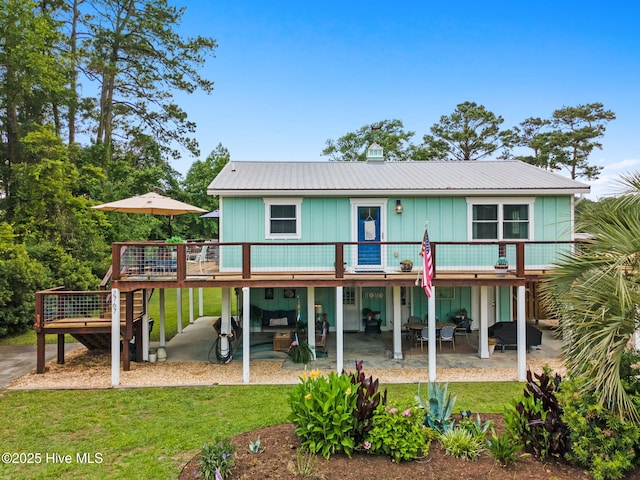 2767 Nags Head Rd SW, Supply, NC 28462 - back of property featuring a patio, a deck, a yard, and metal roof