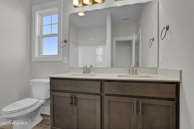 141 Talbert Dr, Rocky Point, NC 28457 - full bath featuring double vanity, baseboards, toilet, a shower, and wood finished floors