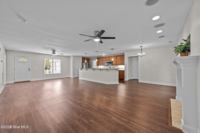 106 Waterside Dr, Bath, NC 27808 - unfurnished living room with ceiling fan, dark wood-style floors, a chandelier, and baseboards